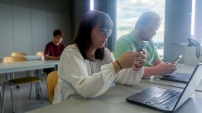students staring at their phones, not listening in lecture and being distracted